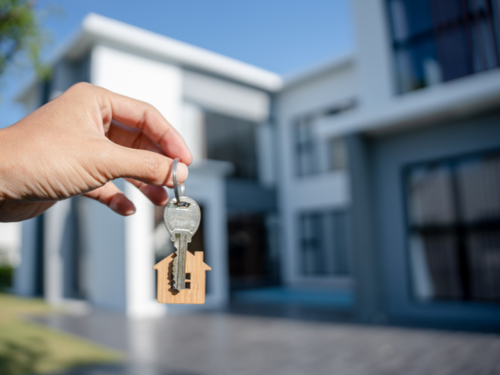 house keys with house in background